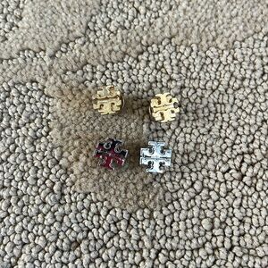 One set of gold and one set of silver Tory Burch studs